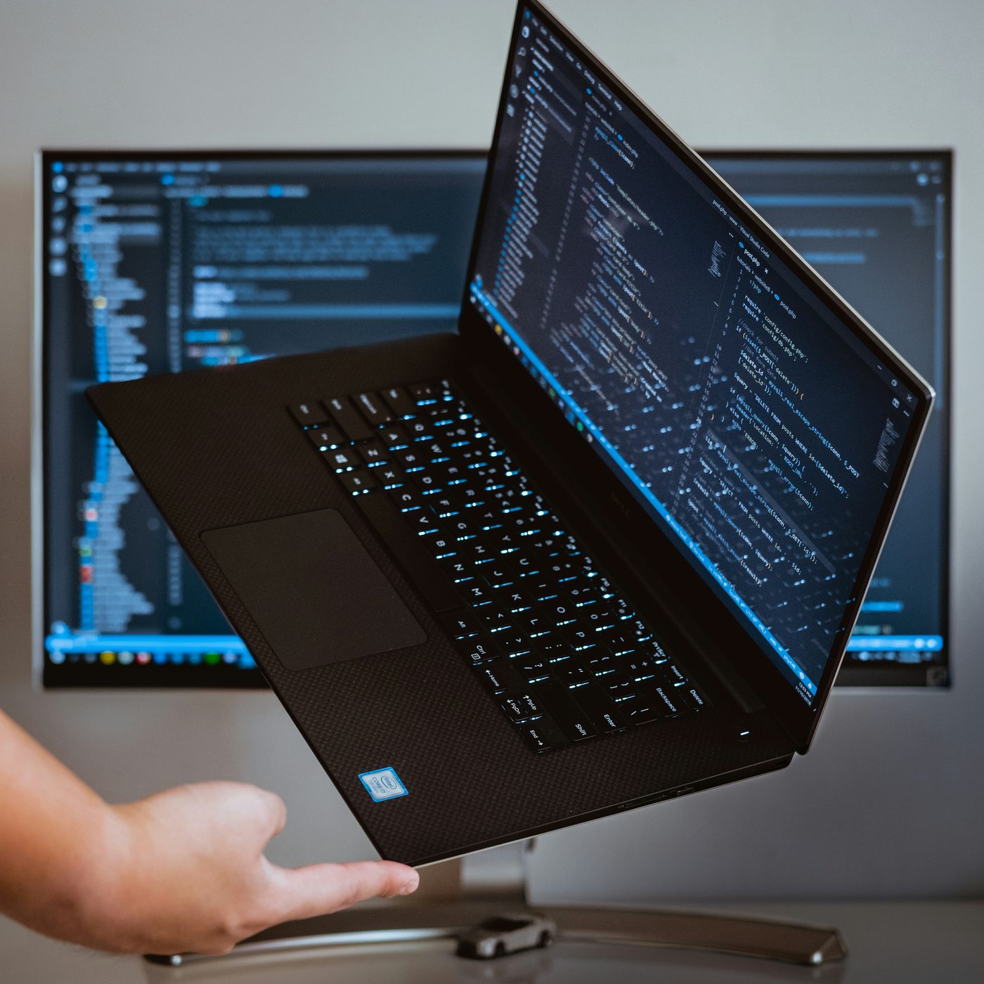 A laptop and desktop monitors running development work.